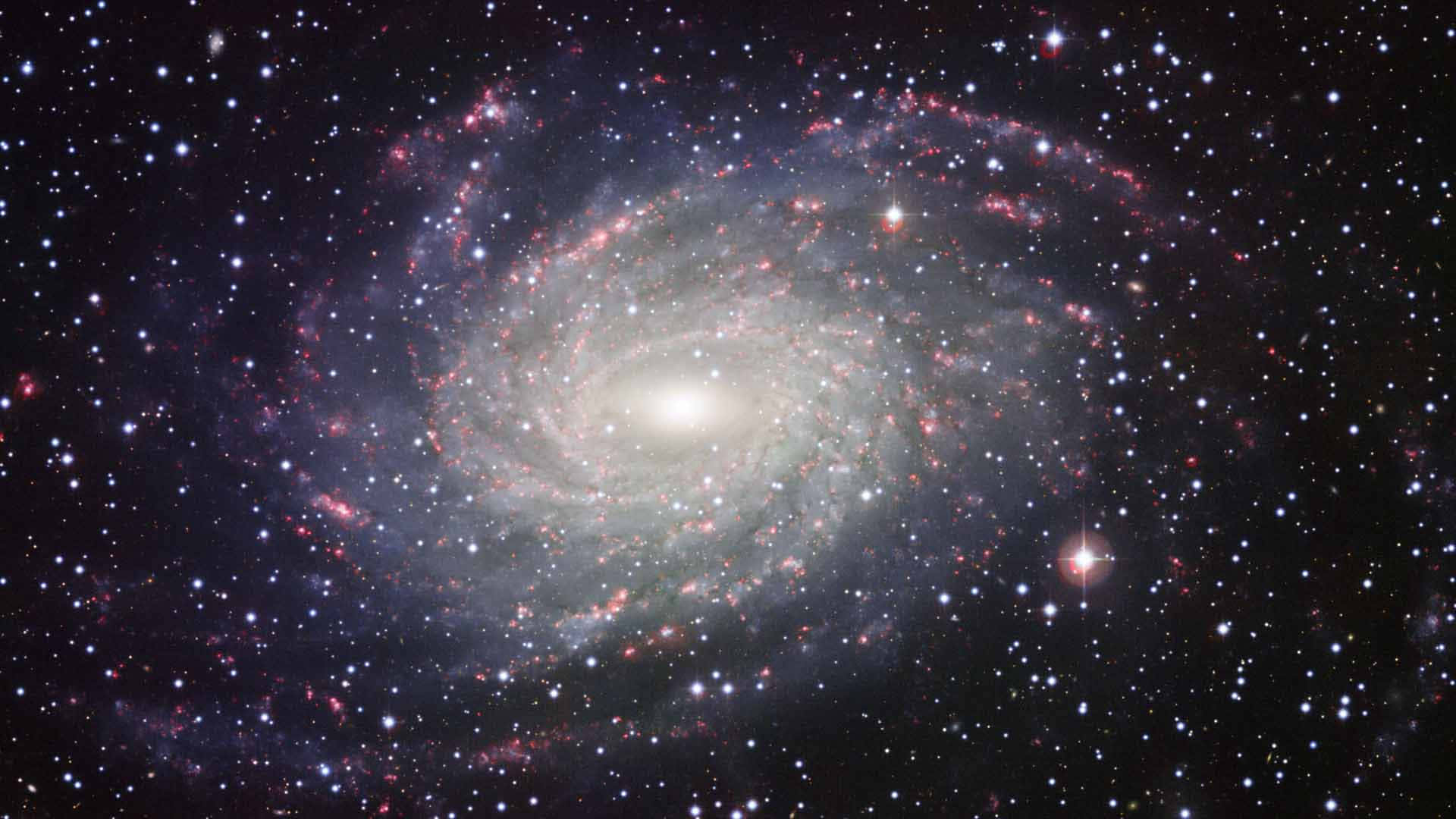 Caption: Majestic Spiral Galaxy Unfolding through the Universe Wallpaper