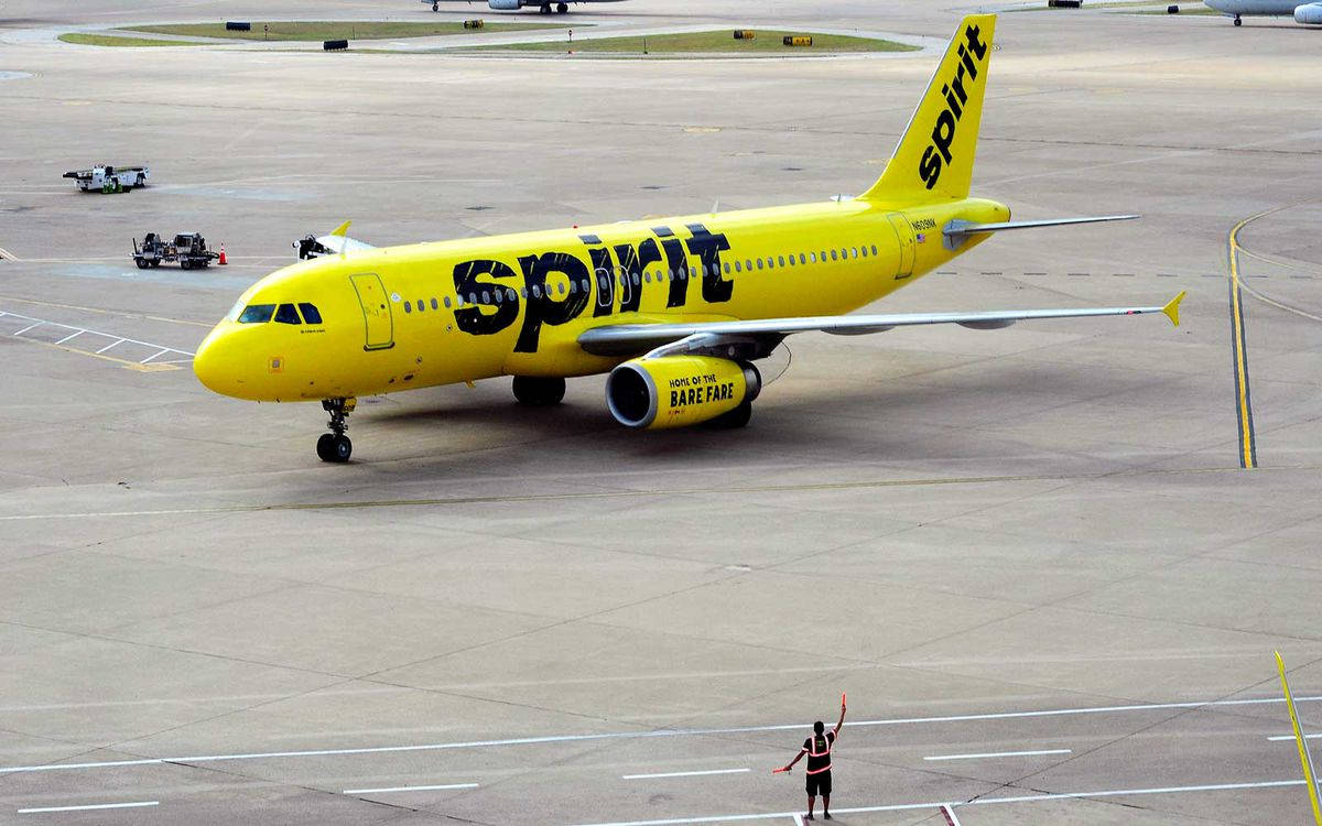 Spirit Airlines Airplane With Airport Police Background