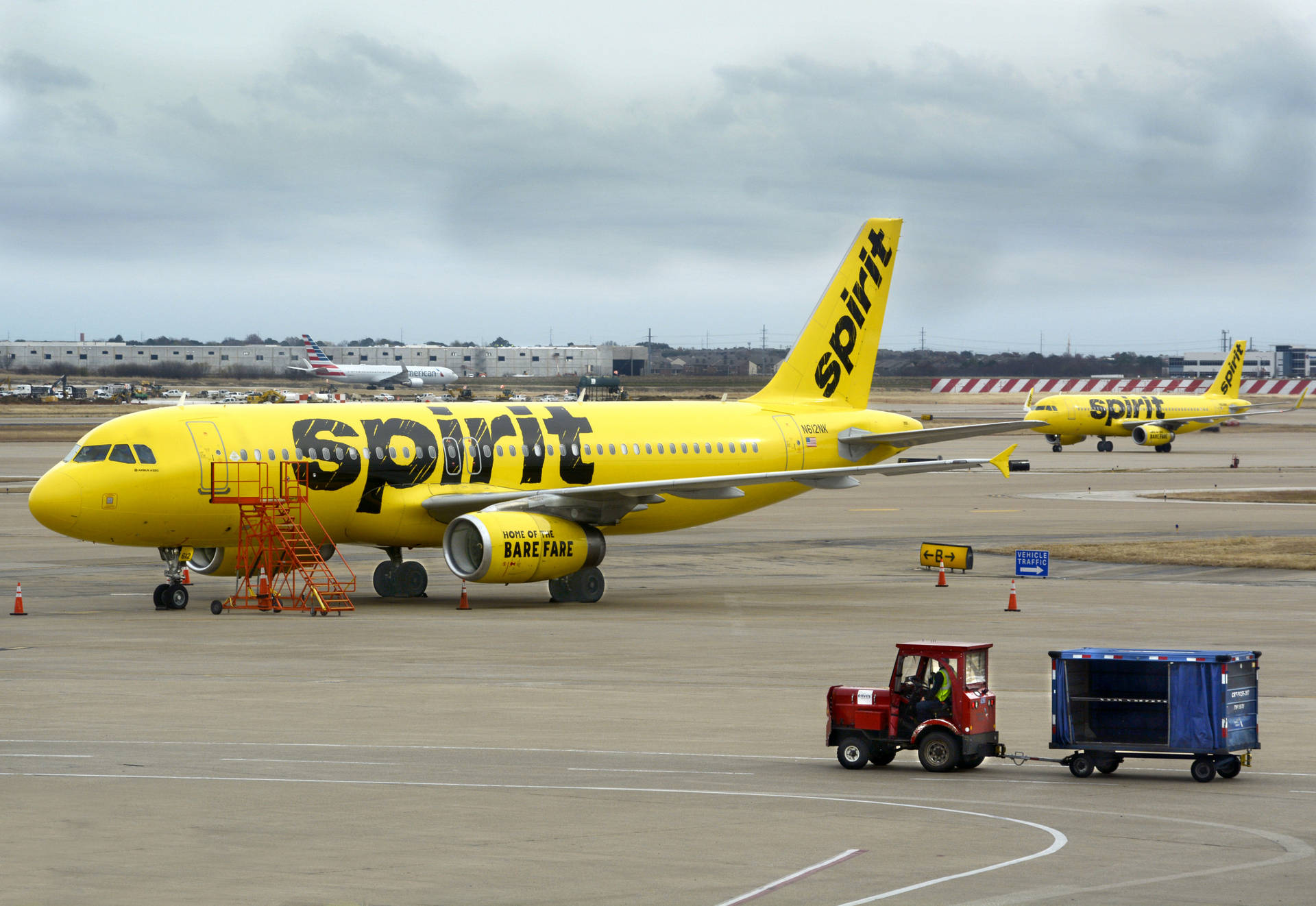 Spirit Airlines Plane And Airport Tractor Background