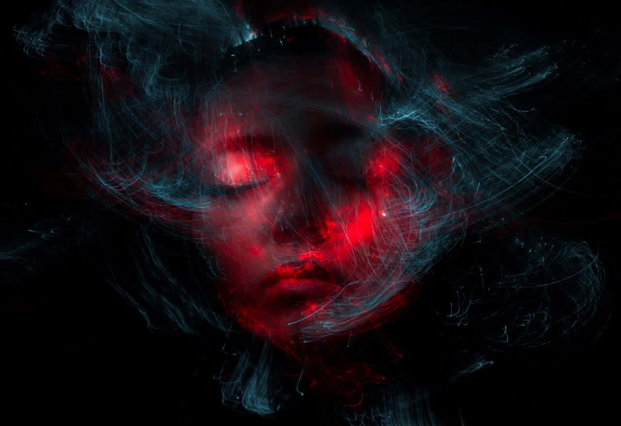 A Woman's Face With Red Light In The Background Wallpaper