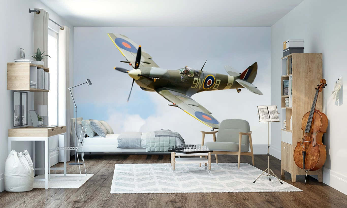 En ikonisk Spitfire-flyvning i luften mod en blå himmel Wallpaper