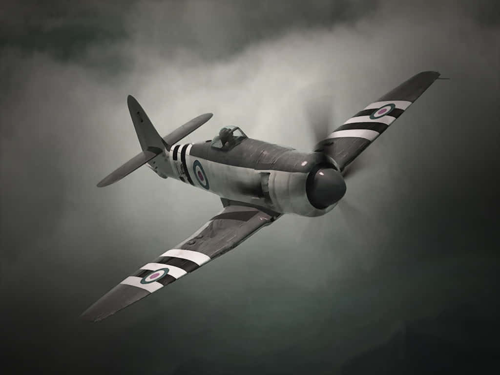 A Black And White Fighter Plane Flying Through The Sky Wallpaper