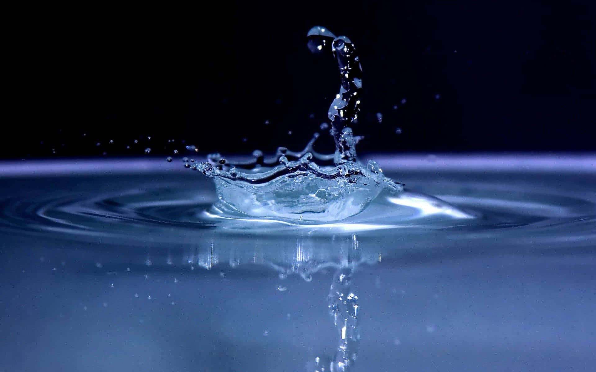 Water Drop Falling On A Black Background