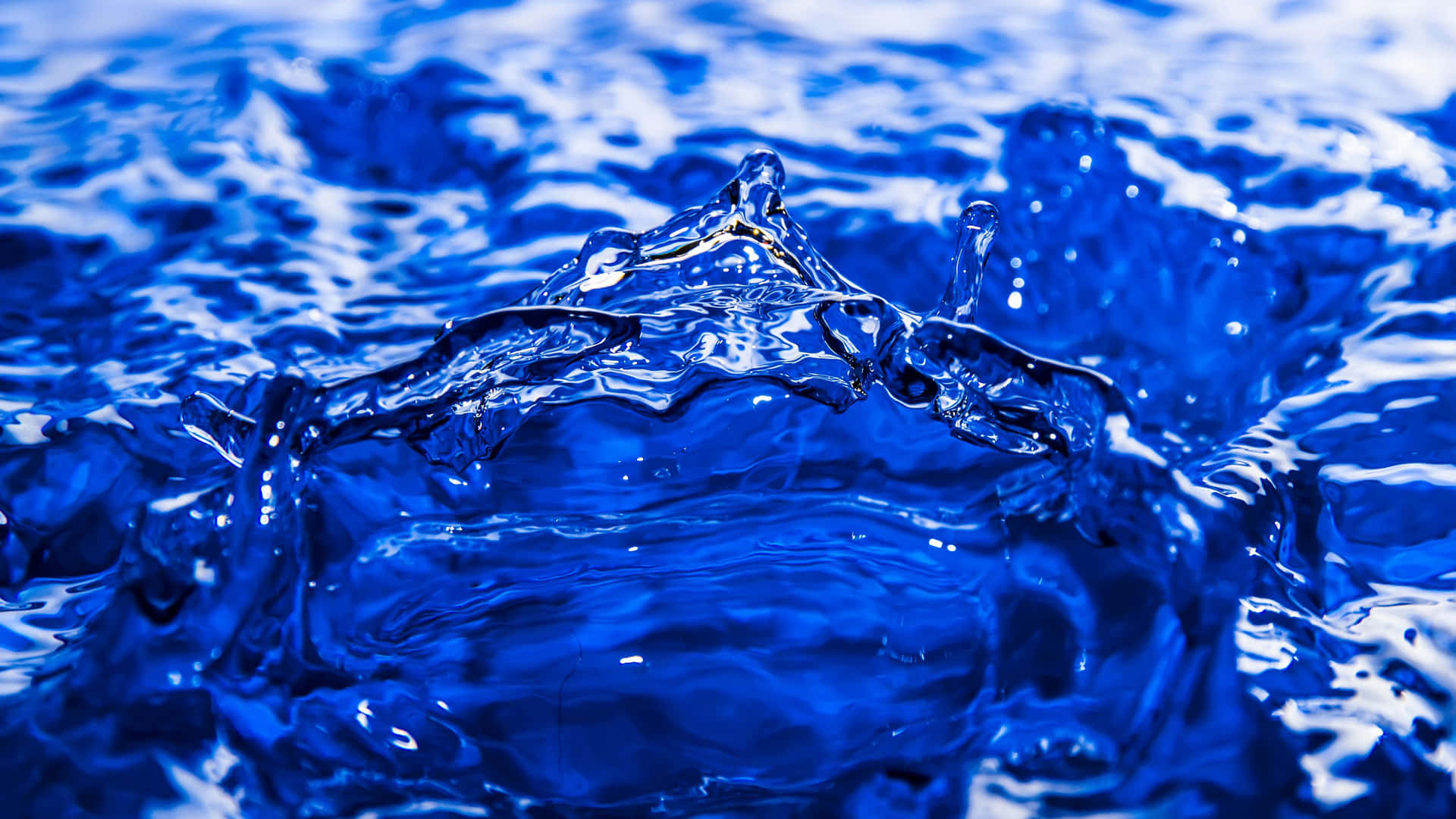 Blue Water Splashing On The Surface Of The Water