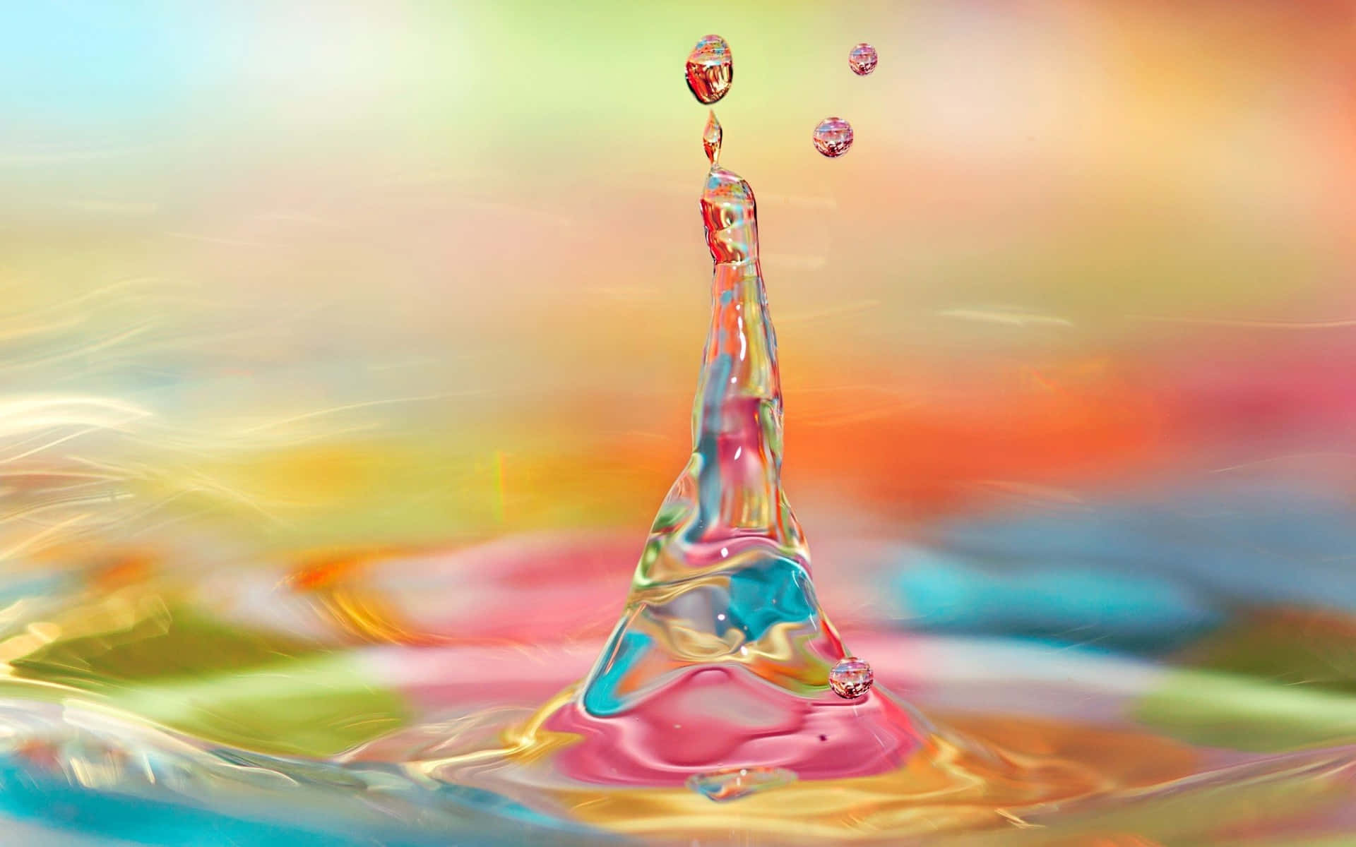 A Colorful Water Drop Is Falling Into A Colorful Background