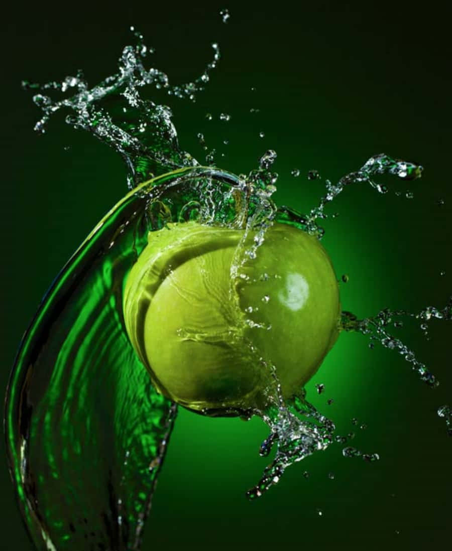 Green Apple Splashing Water On Green Background