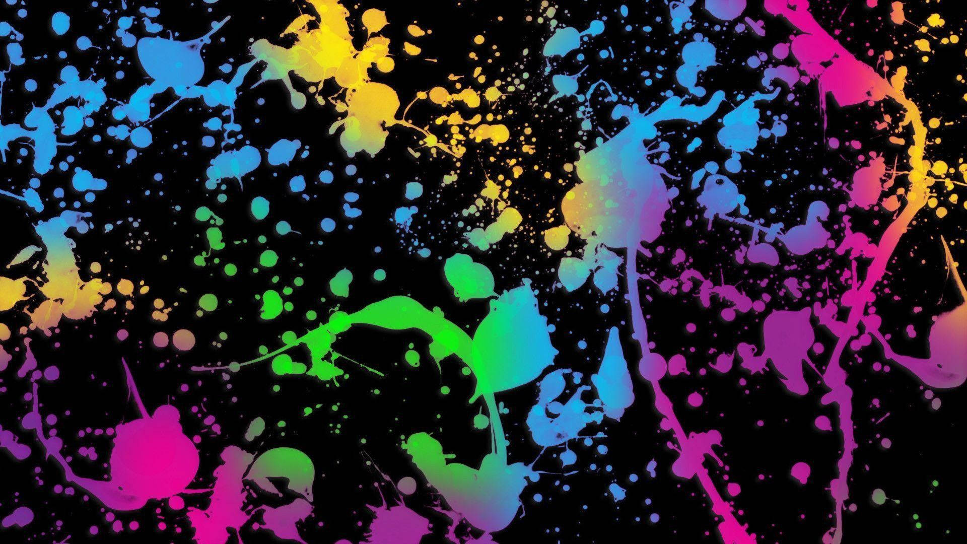 A Colorful Paint Splatter On A Black Background Wallpaper