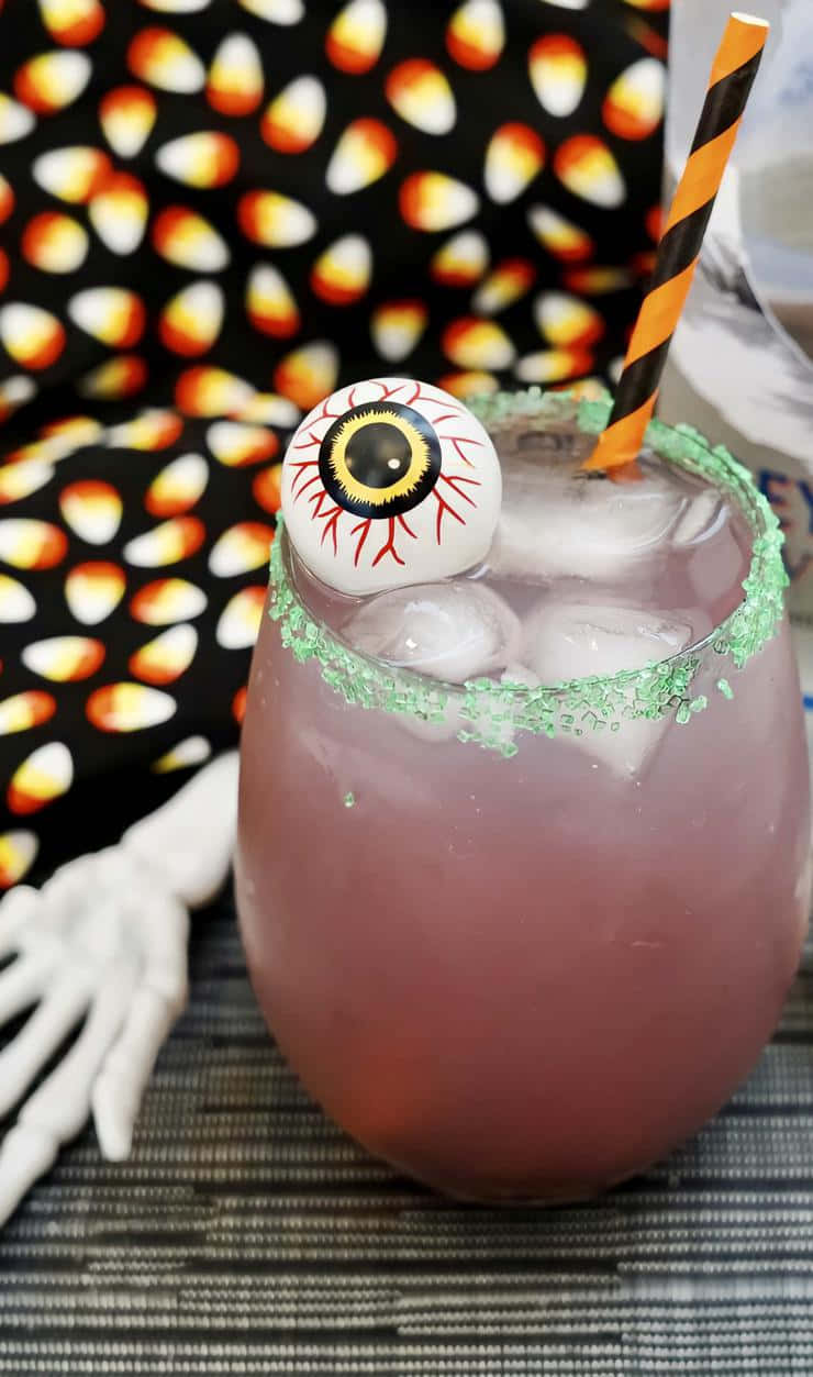 Spooky Halloween Punch With Floating Witch Hand Wallpaper