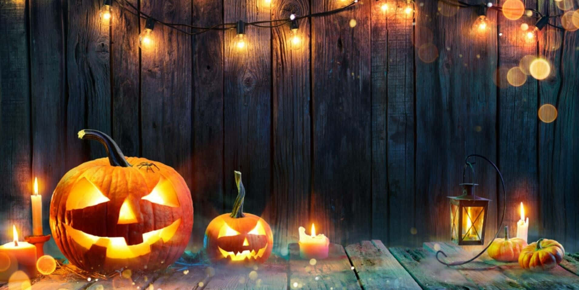 Halloween Pumpkins And Candles On A Wooden Background