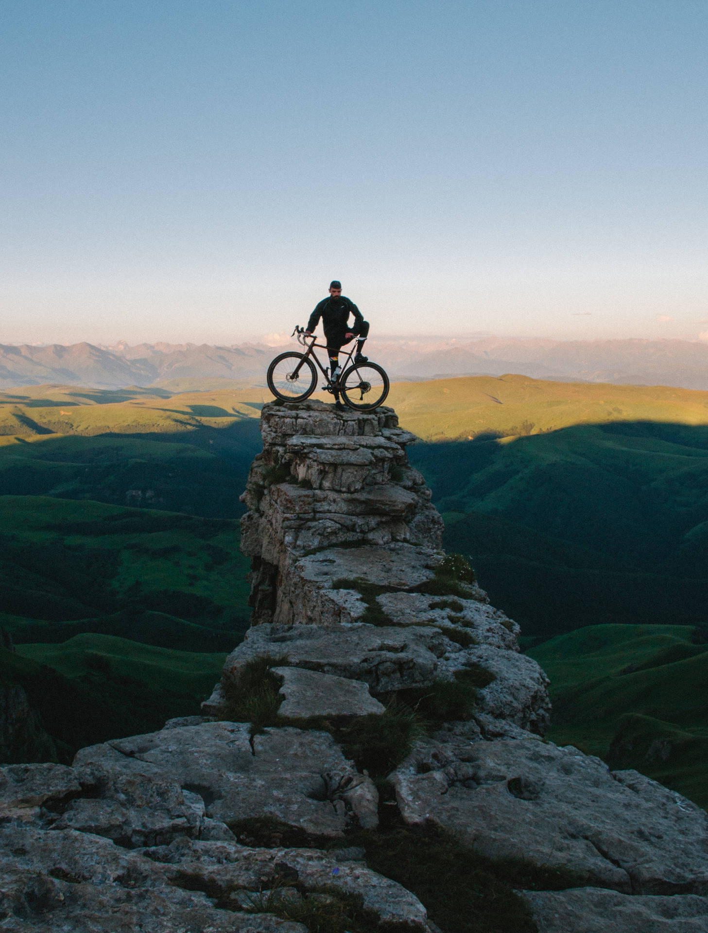 Sport Biker On A Cliff Background