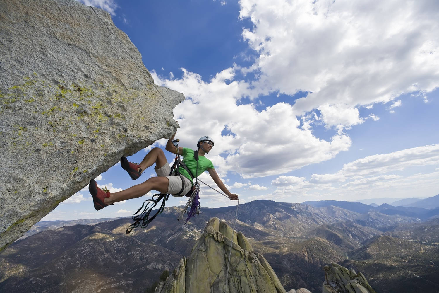 "Determined Sport Climber Ascending a Steep Cliff" Wallpaper