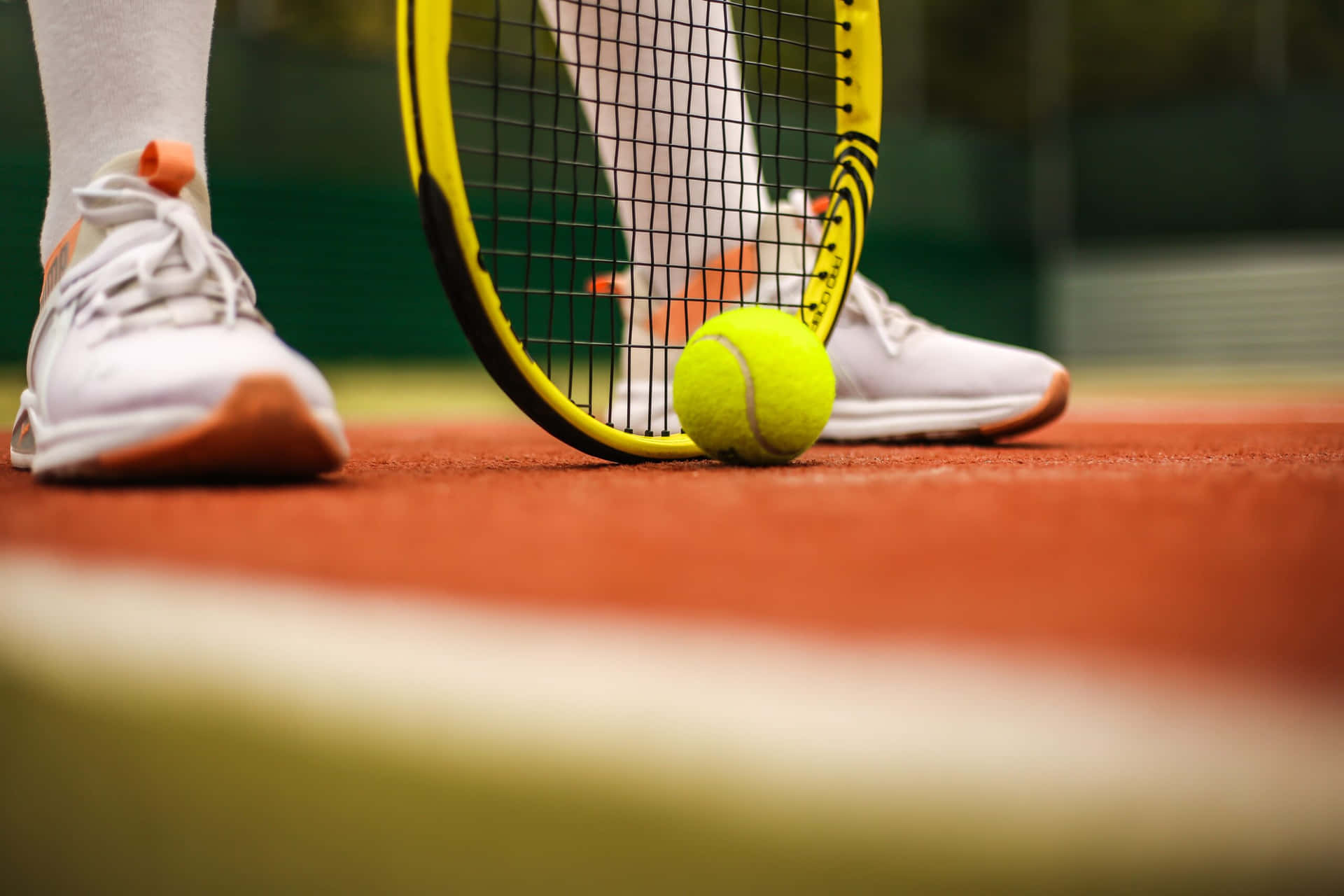 Tennis Player's Feet And Racket On Court