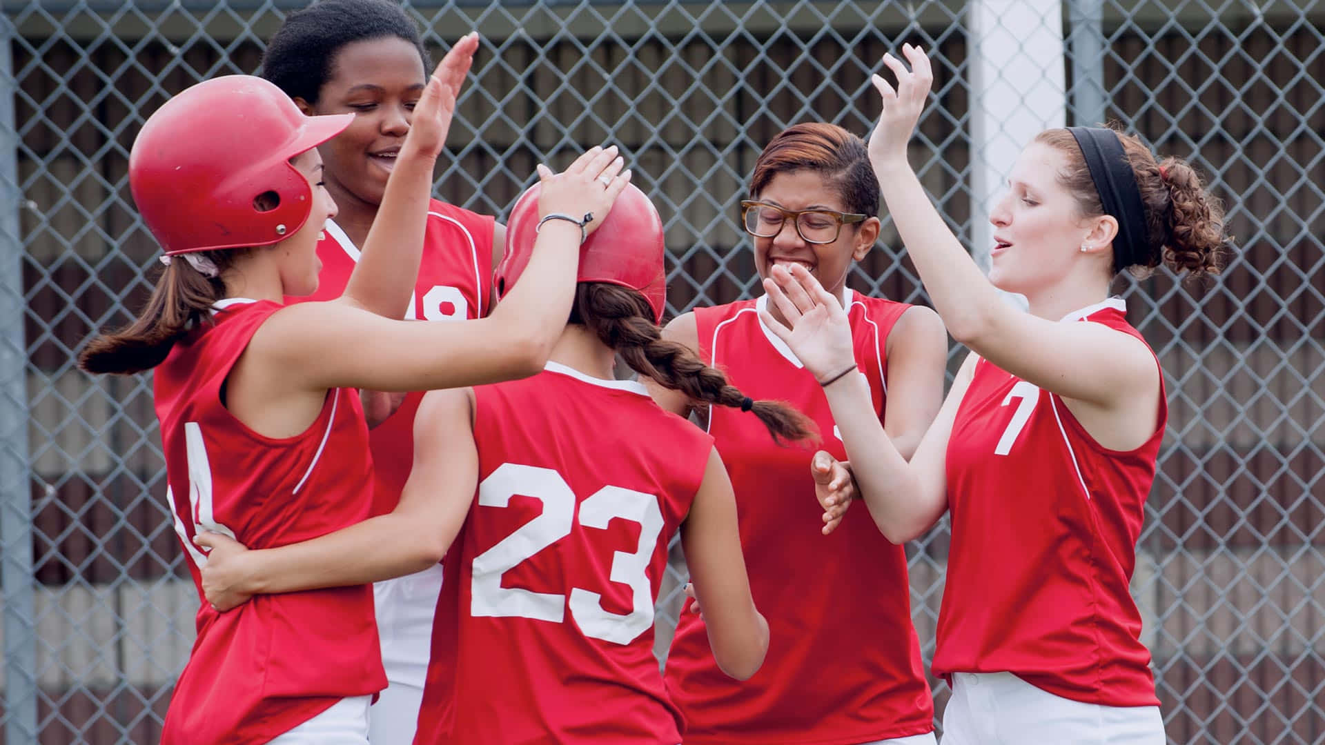 A Group Of Softball Players High Five