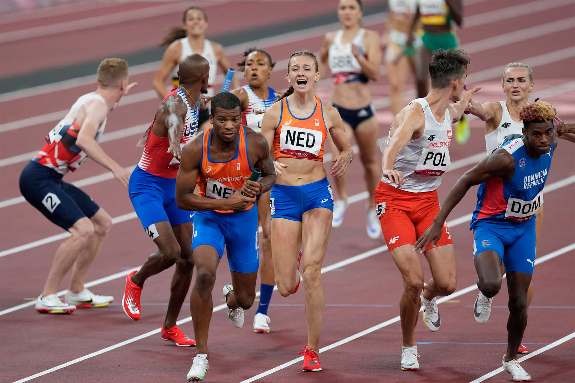 A Group Of Athletes Running On A Track