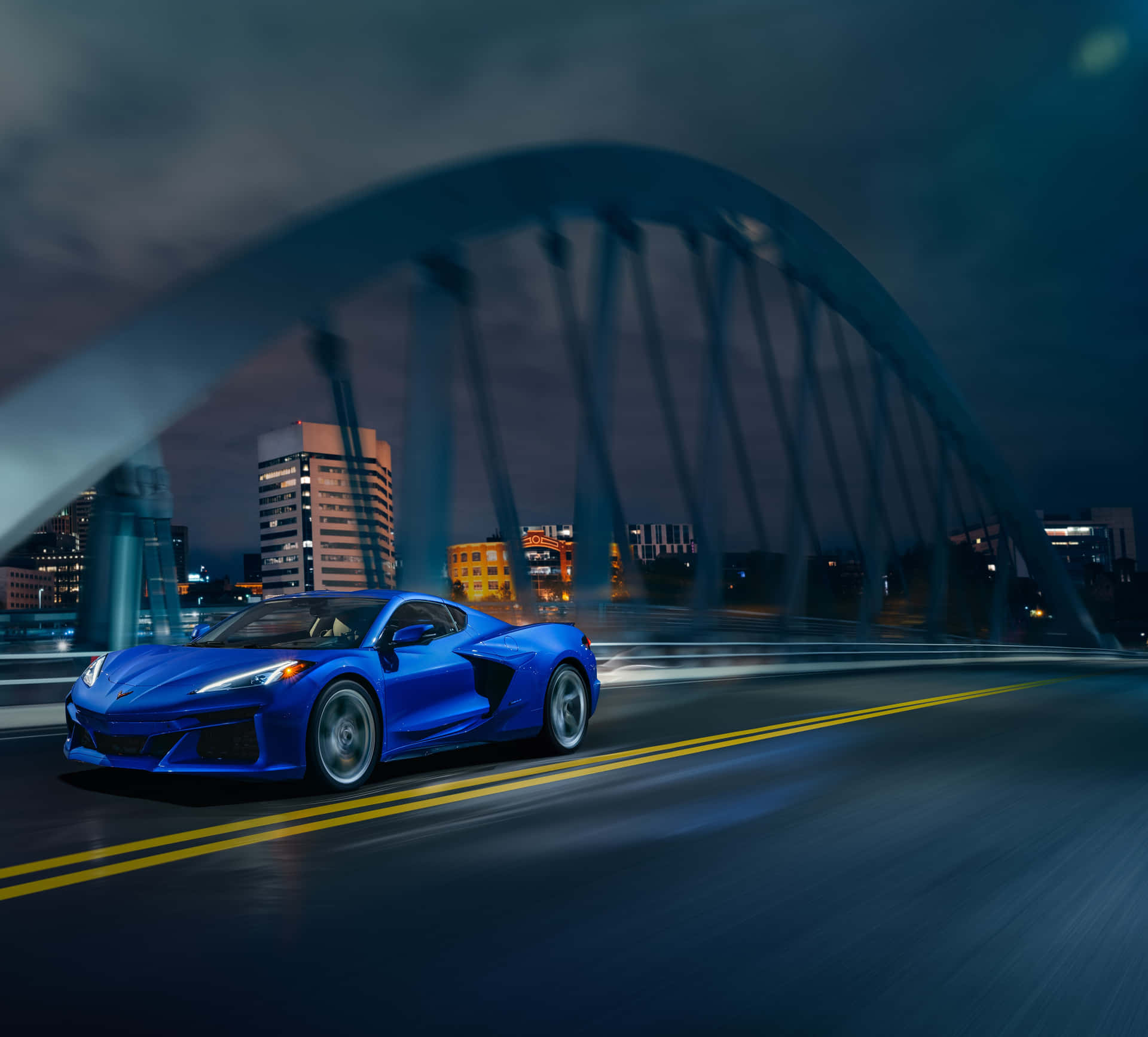 The Blue Corvette C7 Driving On A Bridge At Night
