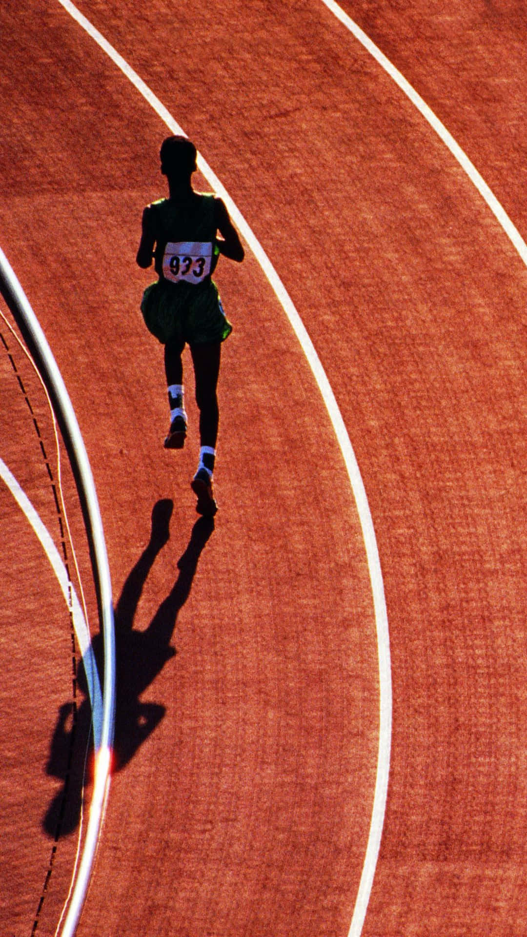 A Man Running On A Track Wallpaper