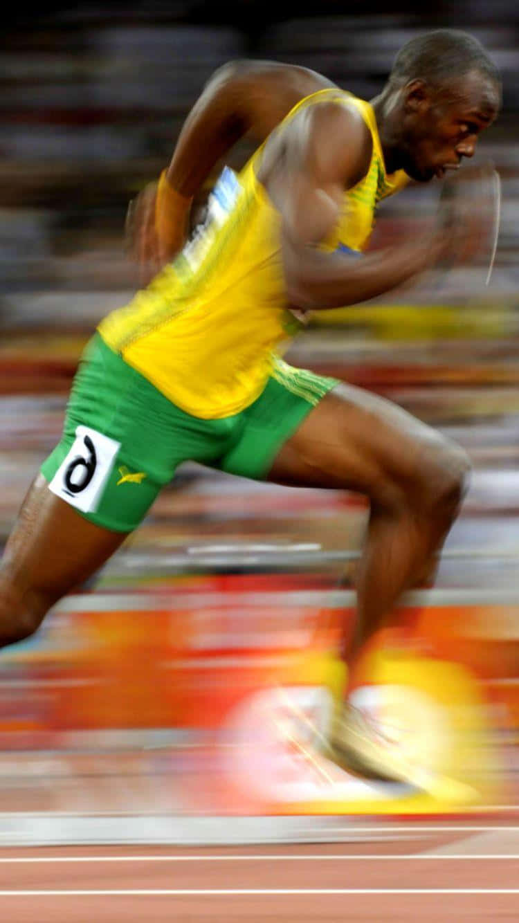 A Man Running On A Track With Blurred Background Wallpaper
