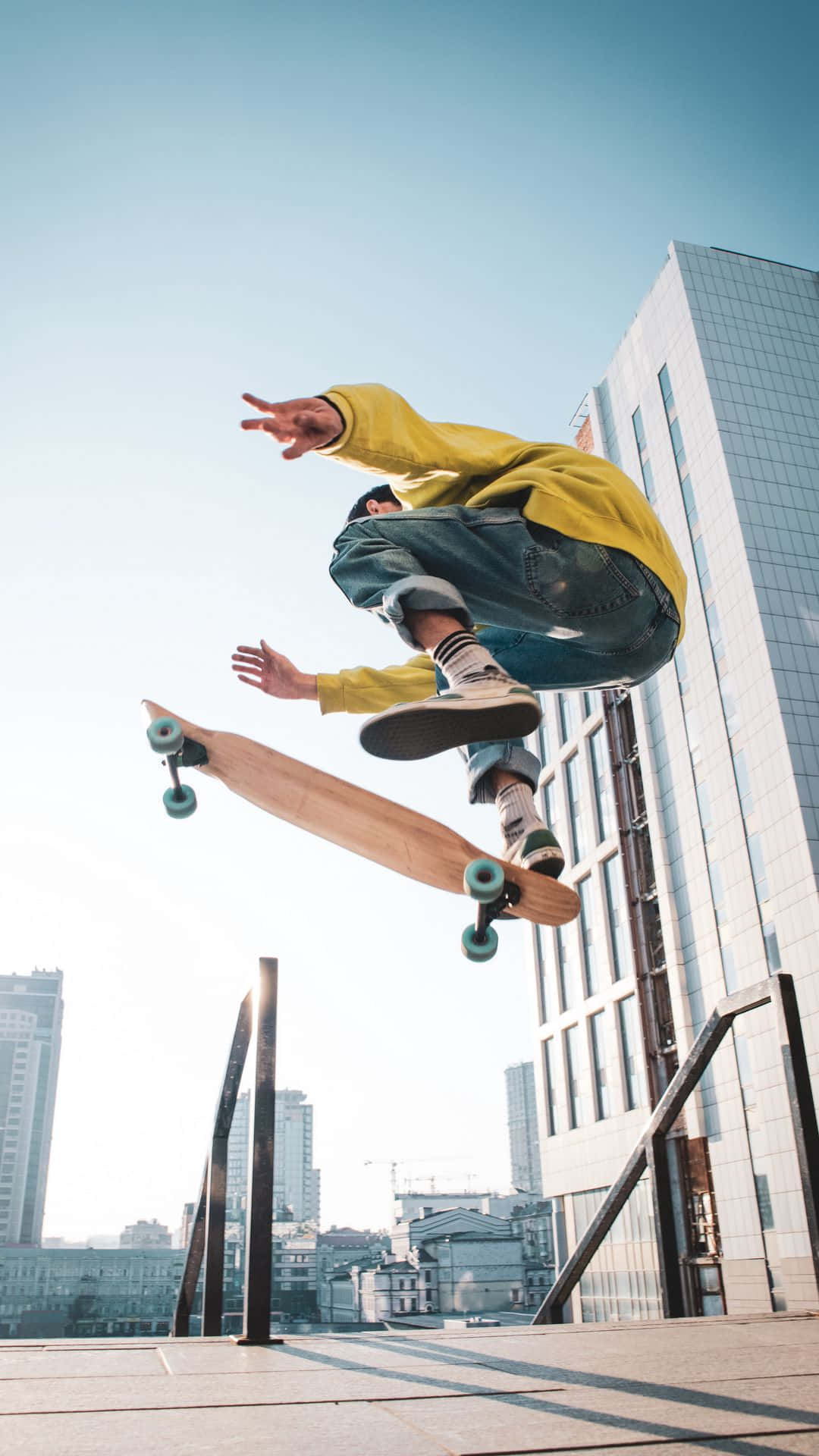 A Skateboarder Doing Tricks In The Air Wallpaper