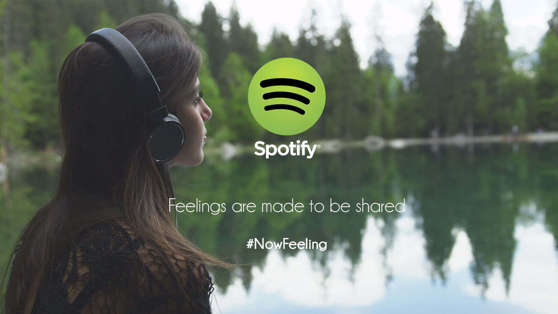 Spotify - A Woman Wearing Headphones In Front Of A Lake