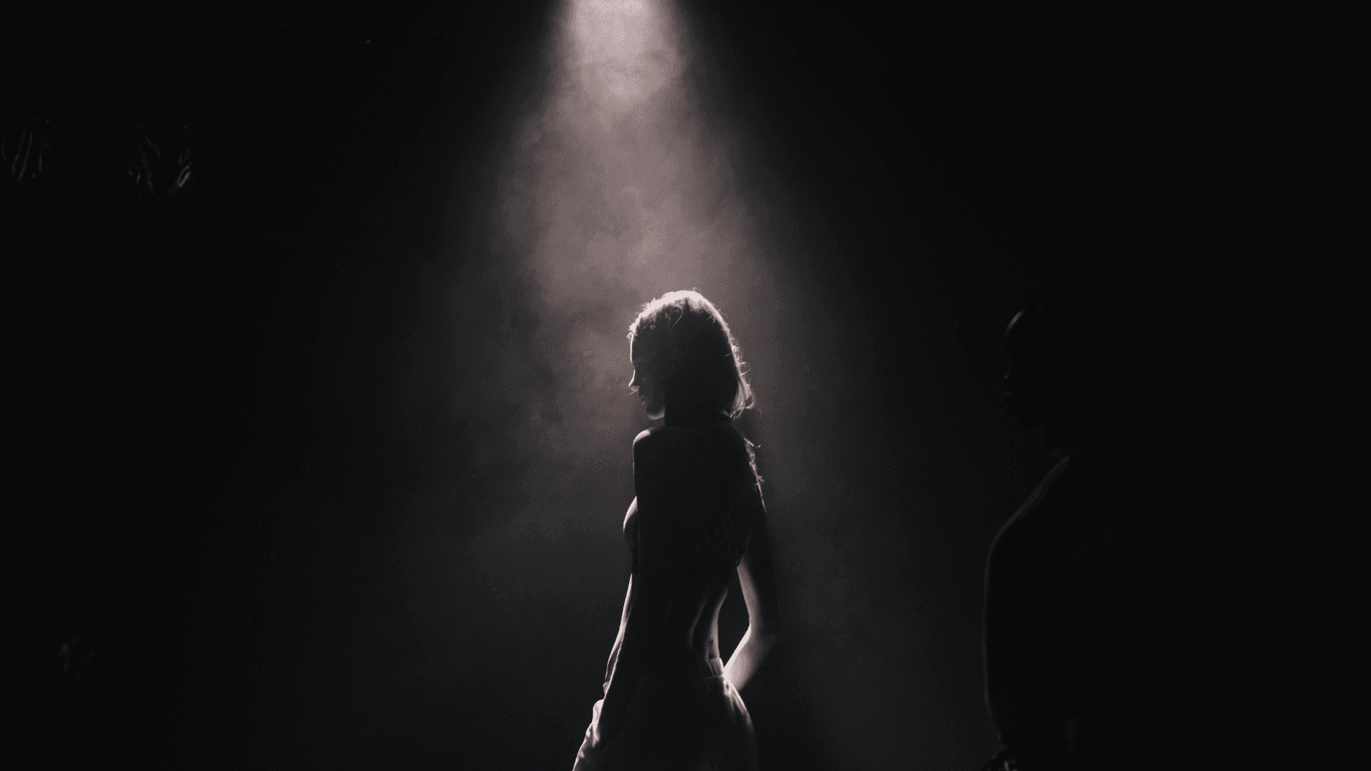 Silhouette Of A Woman Standing In The Dark