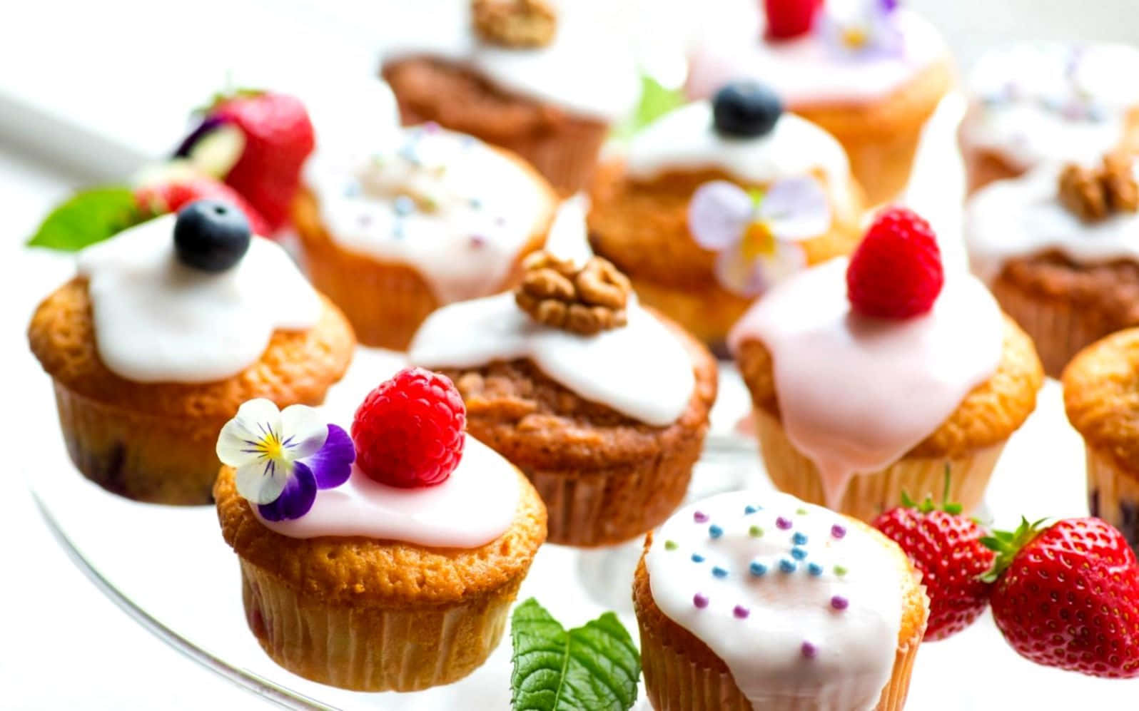 A fresh berry tart surrounded by colorful flowers on a wooden table Wallpaper