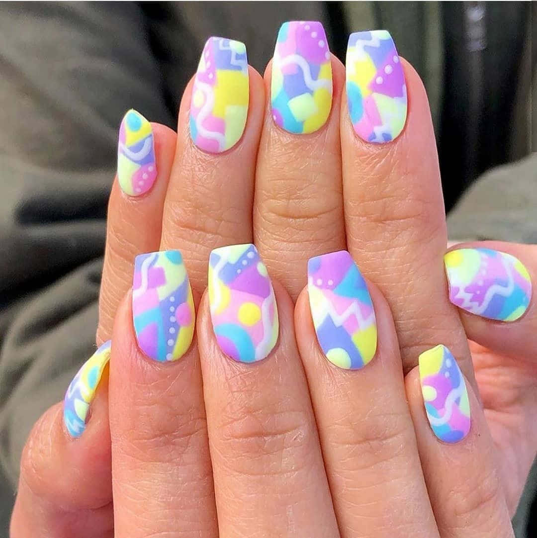 Vibrant Spring Nails with Delicate Flower Accents Wallpaper