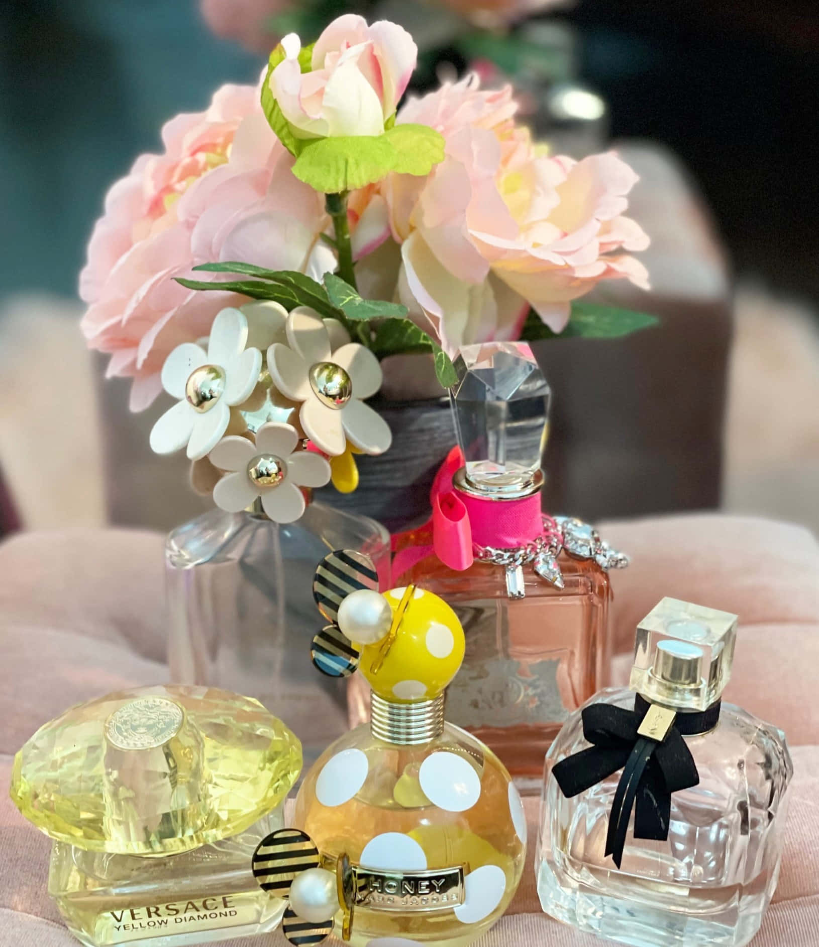 Delightful Spring Perfume in a Crystal Bottle surrounded by fresh flowers Wallpaper