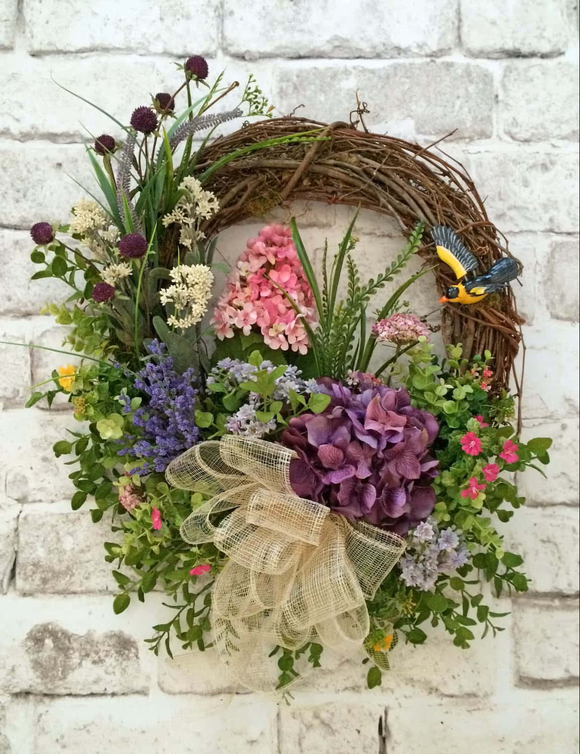 Beautiful Spring Wreath with Colorful Flowers and Green Leaves Wallpaper