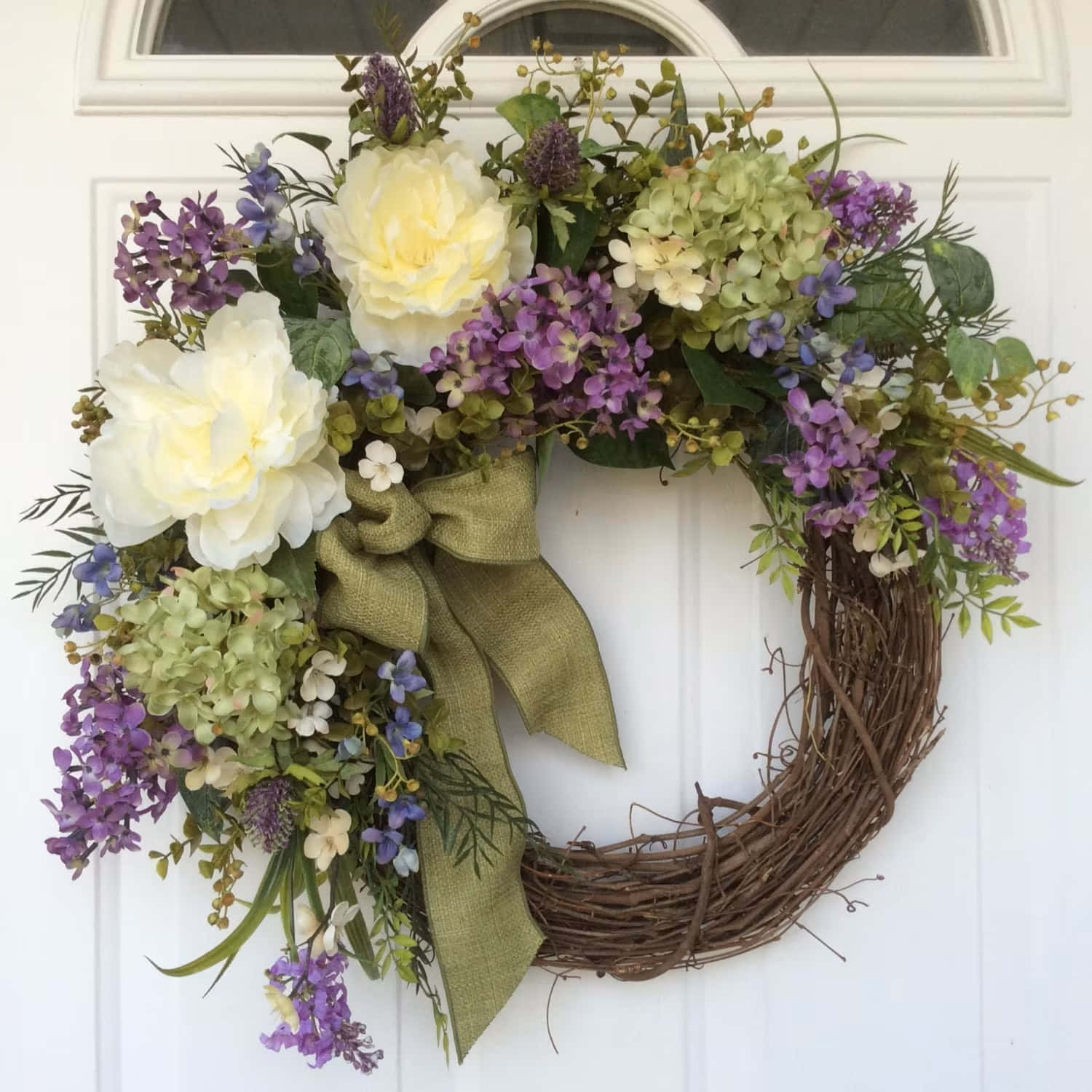 Beautiful Spring Wreath with Colorful Flowers on White Door Wallpaper