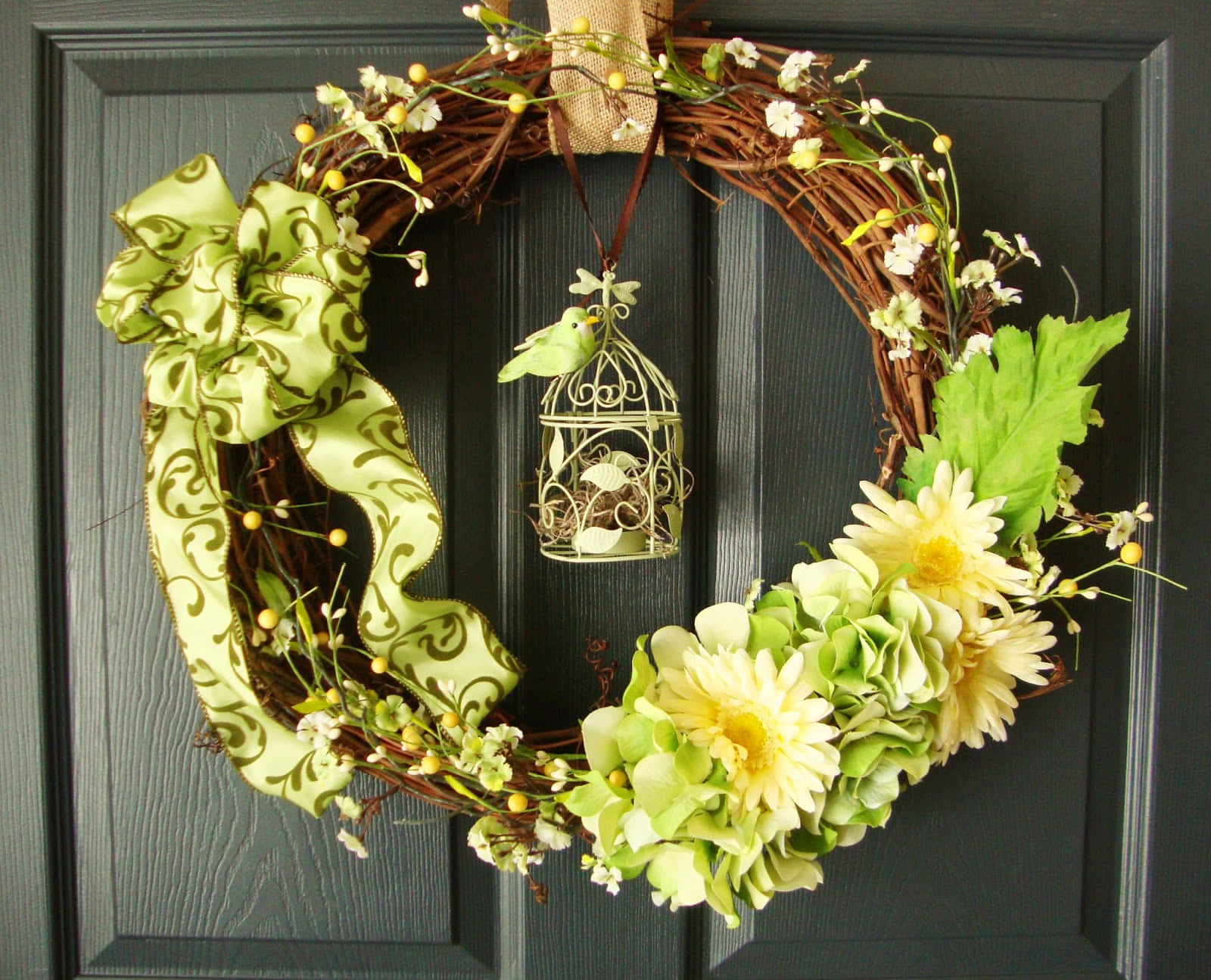 Elegant Spring Wreath Adorning a Rustic Wooden Door Wallpaper
