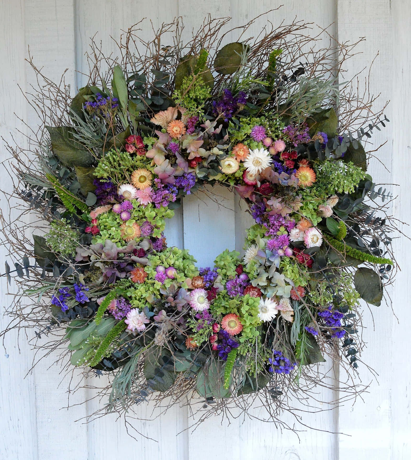 Beautiful Spring Wreath Adorning a Front Door Wallpaper