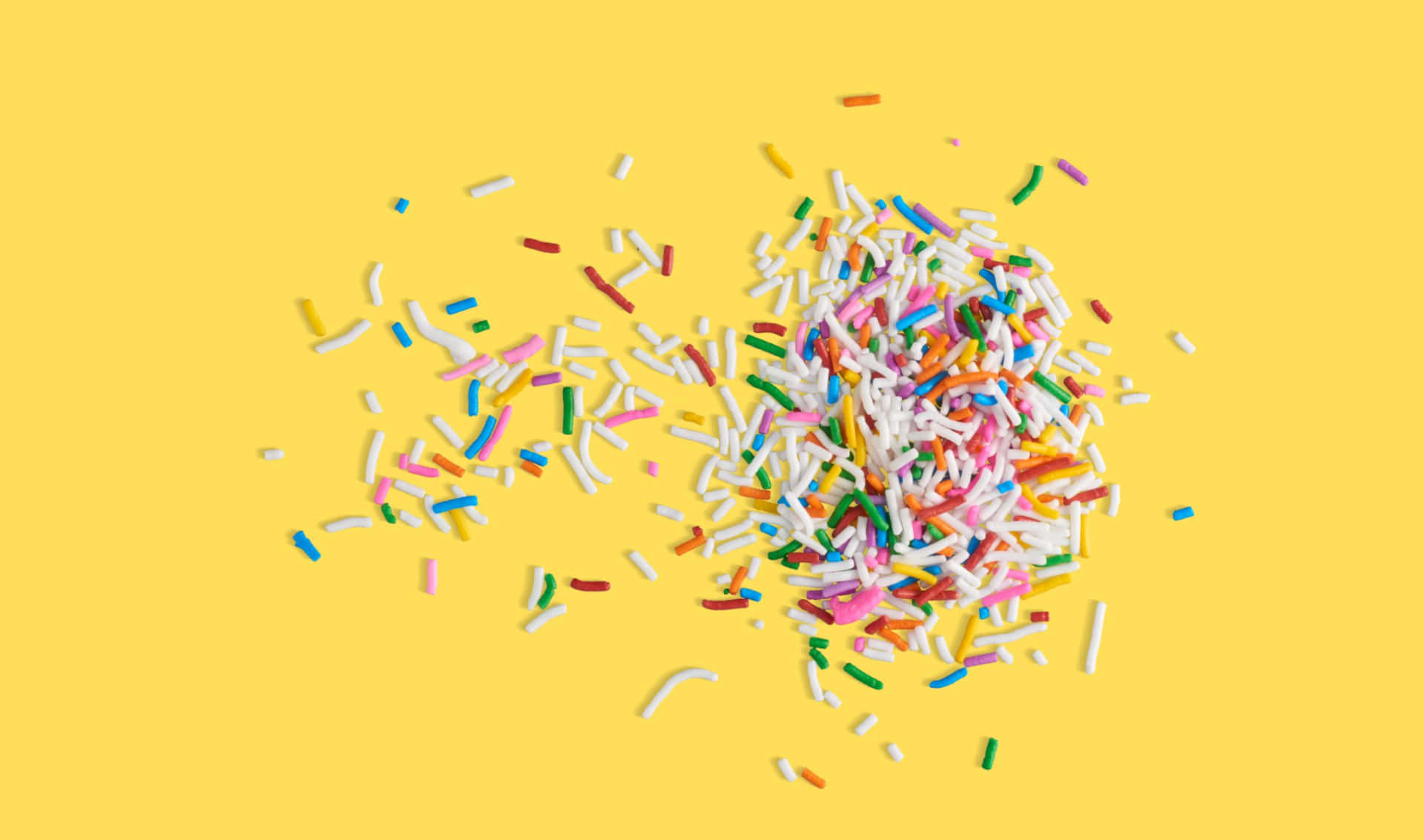 Scattered Sprinkles On Yellow Background