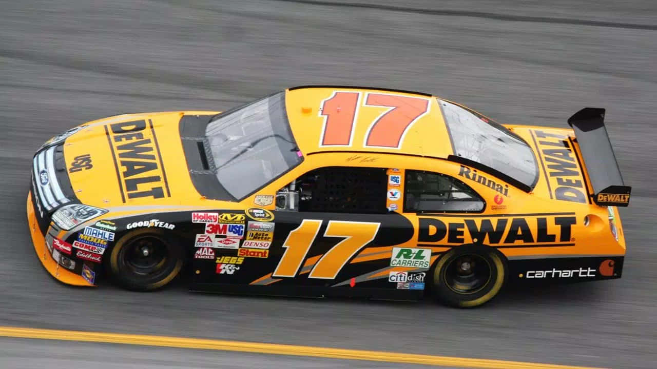 A Yellow And Black Nascar Car Driving On A Track Wallpaper