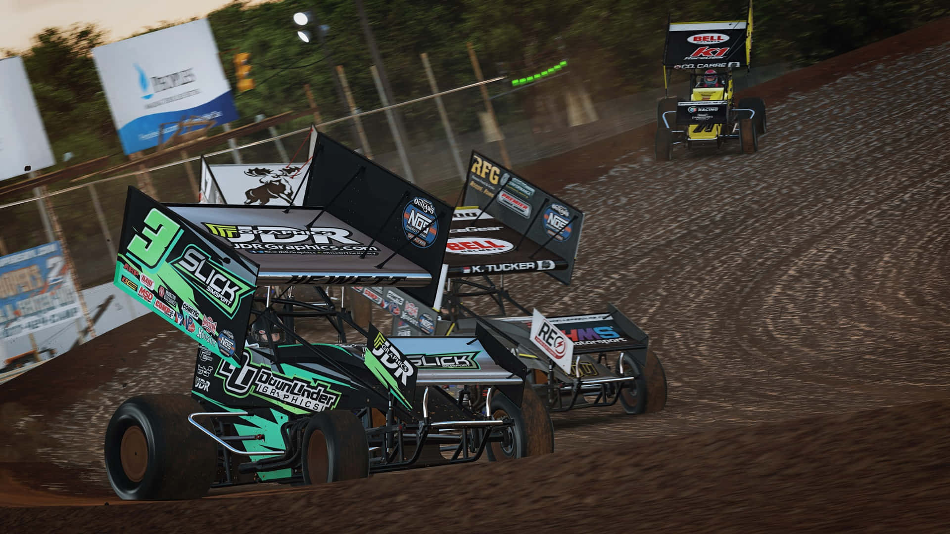 A Dirt Track With Dirt Cars Racing Down The Track Wallpaper