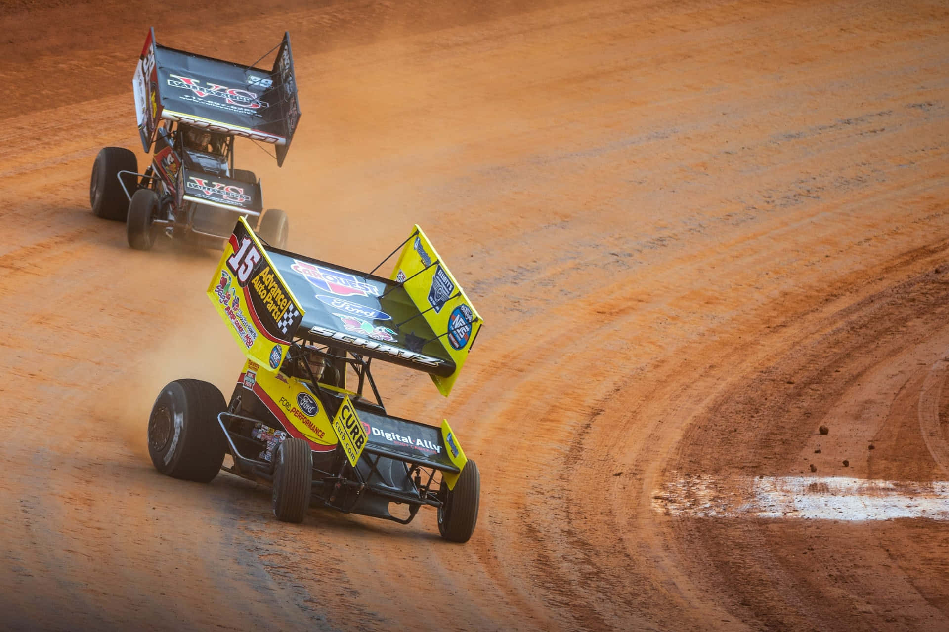 Two Dirt Track Racing Cars On A Dirt Track Wallpaper