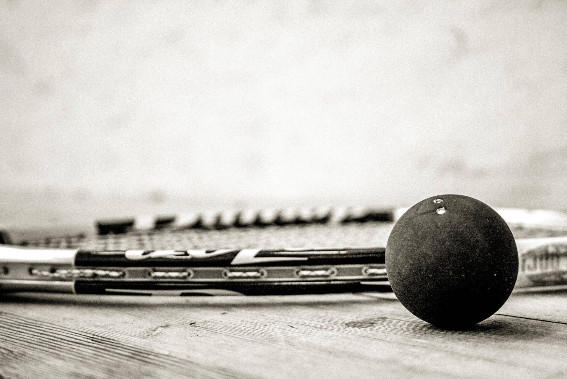 Squash Racket And Ball Grayscale Background