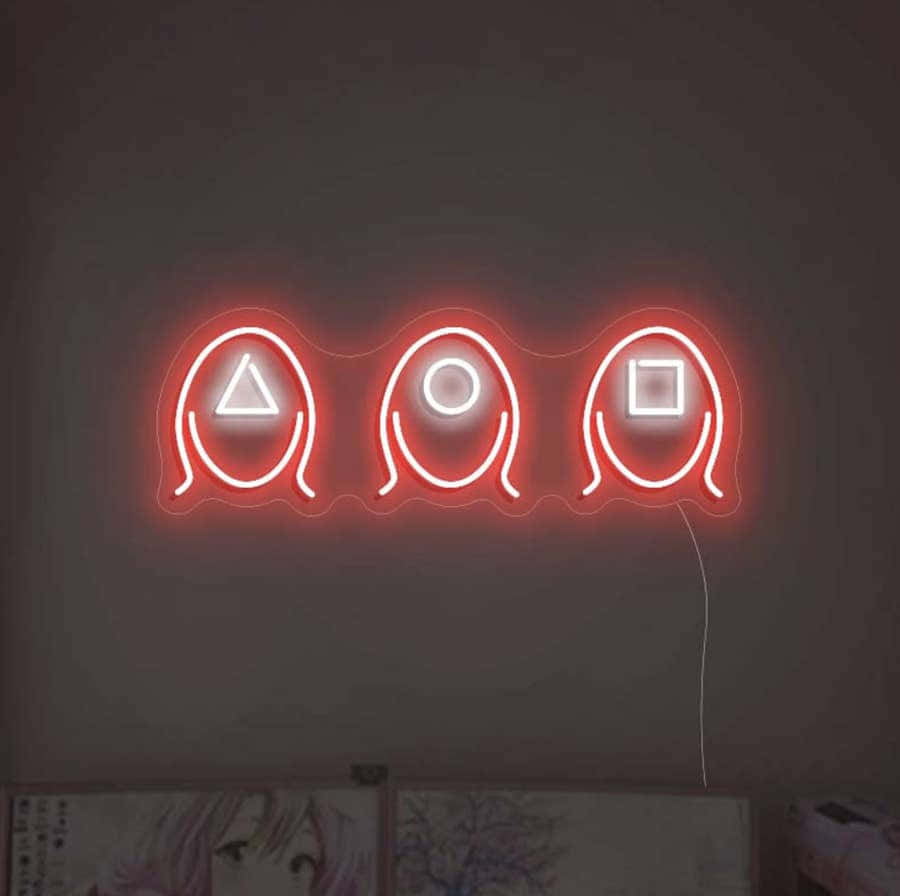 A Neon Sign With Three Faces On It