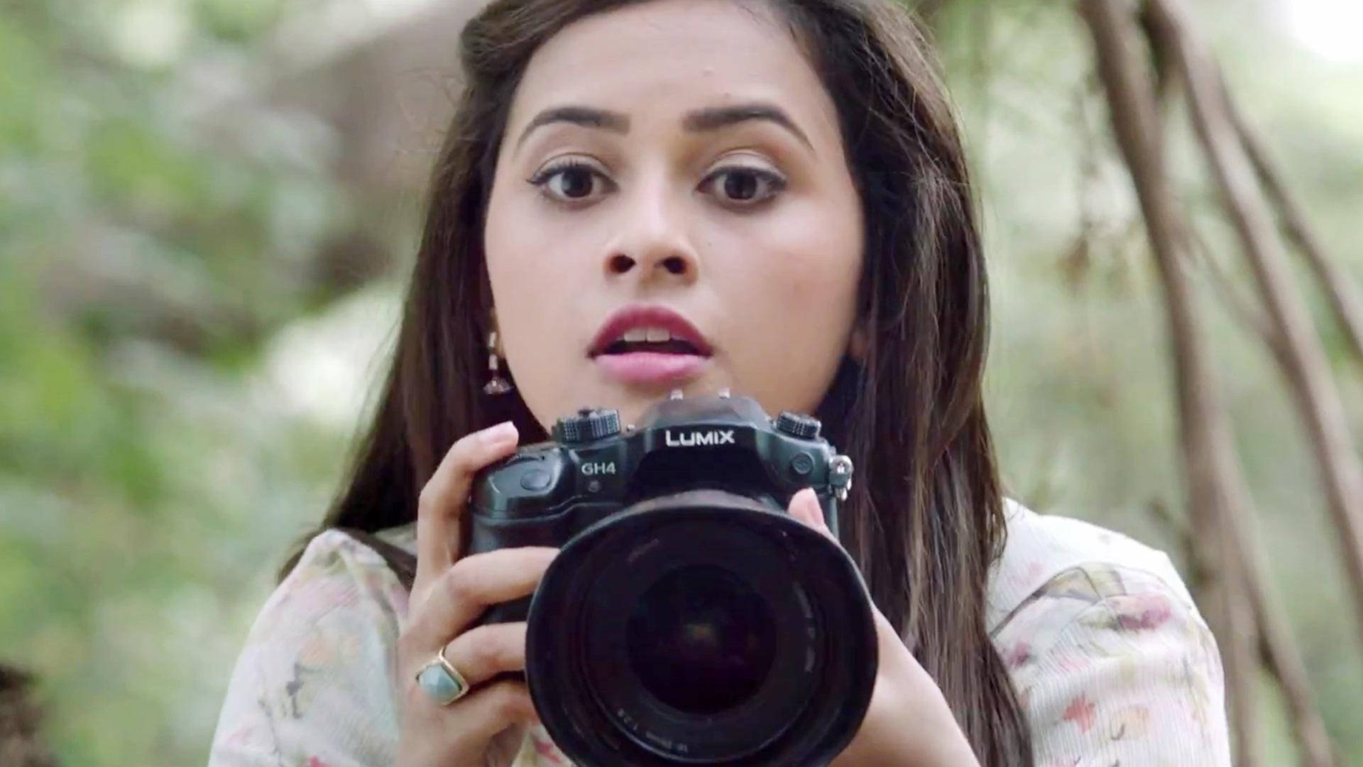 Sri Divya Holding A Camera Wallpaper