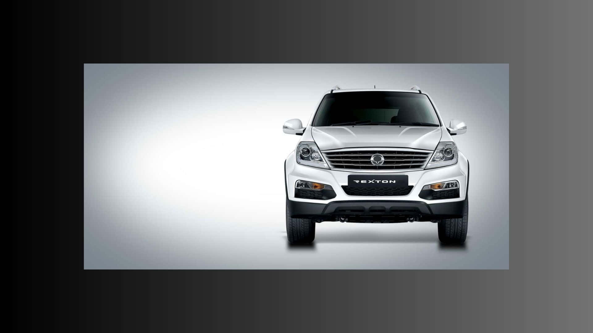 Sleek SsangYong SUV driving on a picturesque road Wallpaper