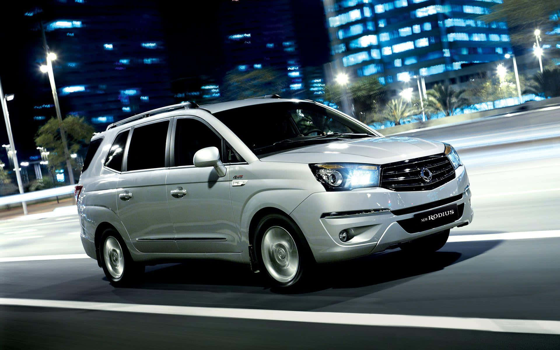 Ssangyong SUV driving on a countryside road Wallpaper