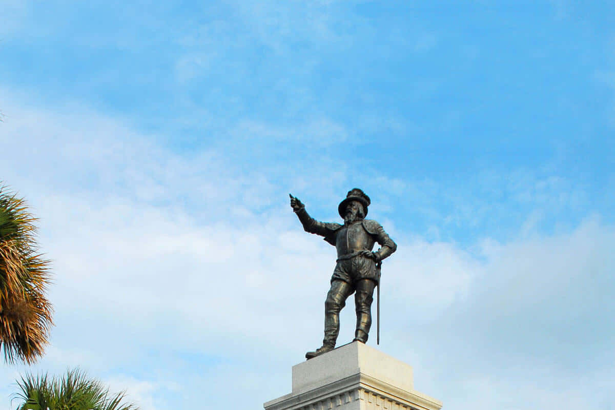 A Statue Of A Man With A Flag On It