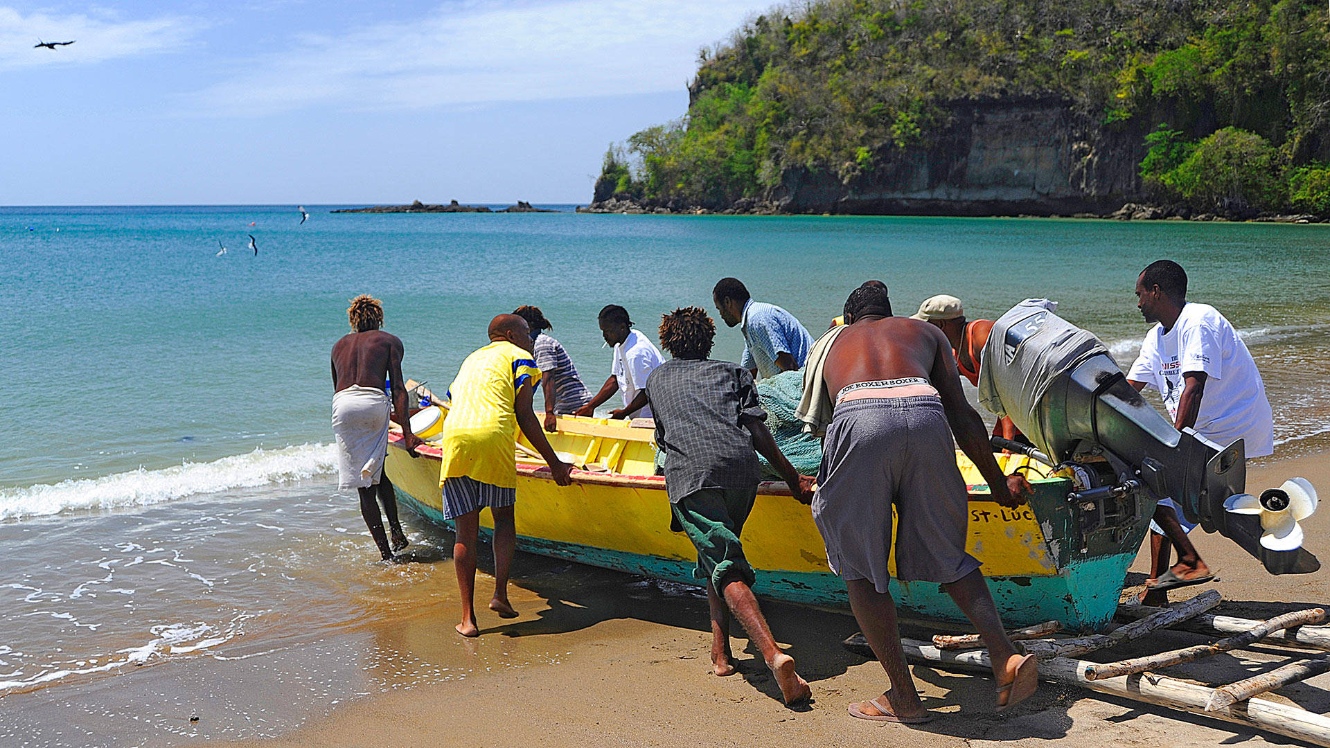 St. Lucia Men Pushing A Boat Wallpaper