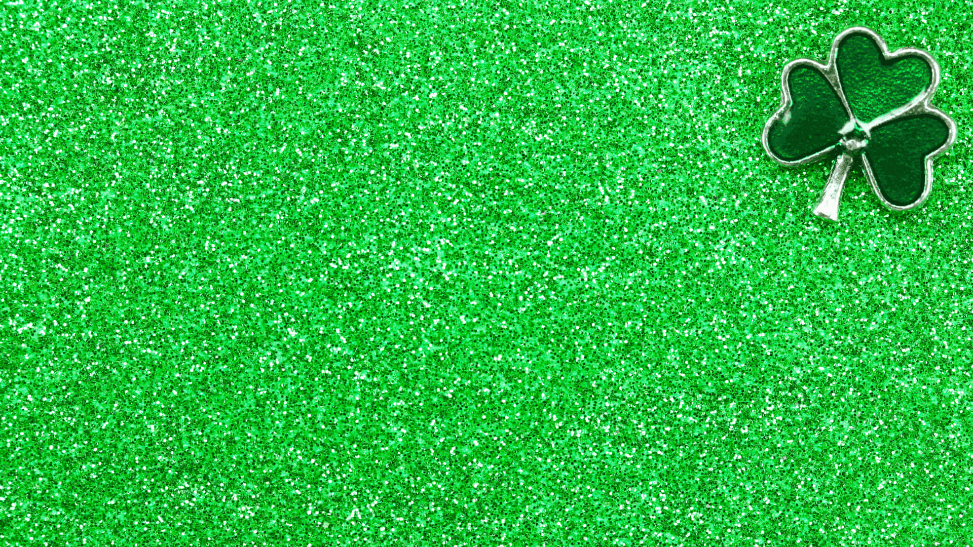 A Green Glitter Background With A Shamrock