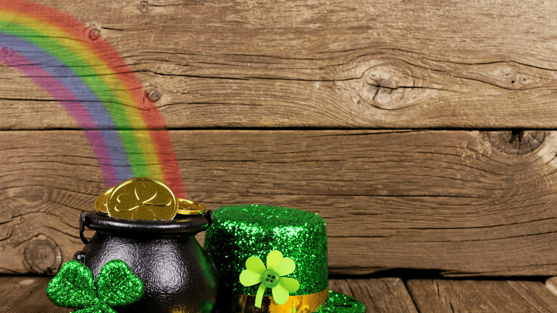 A Rainbow And A Pot Of Gold On A Wooden Background