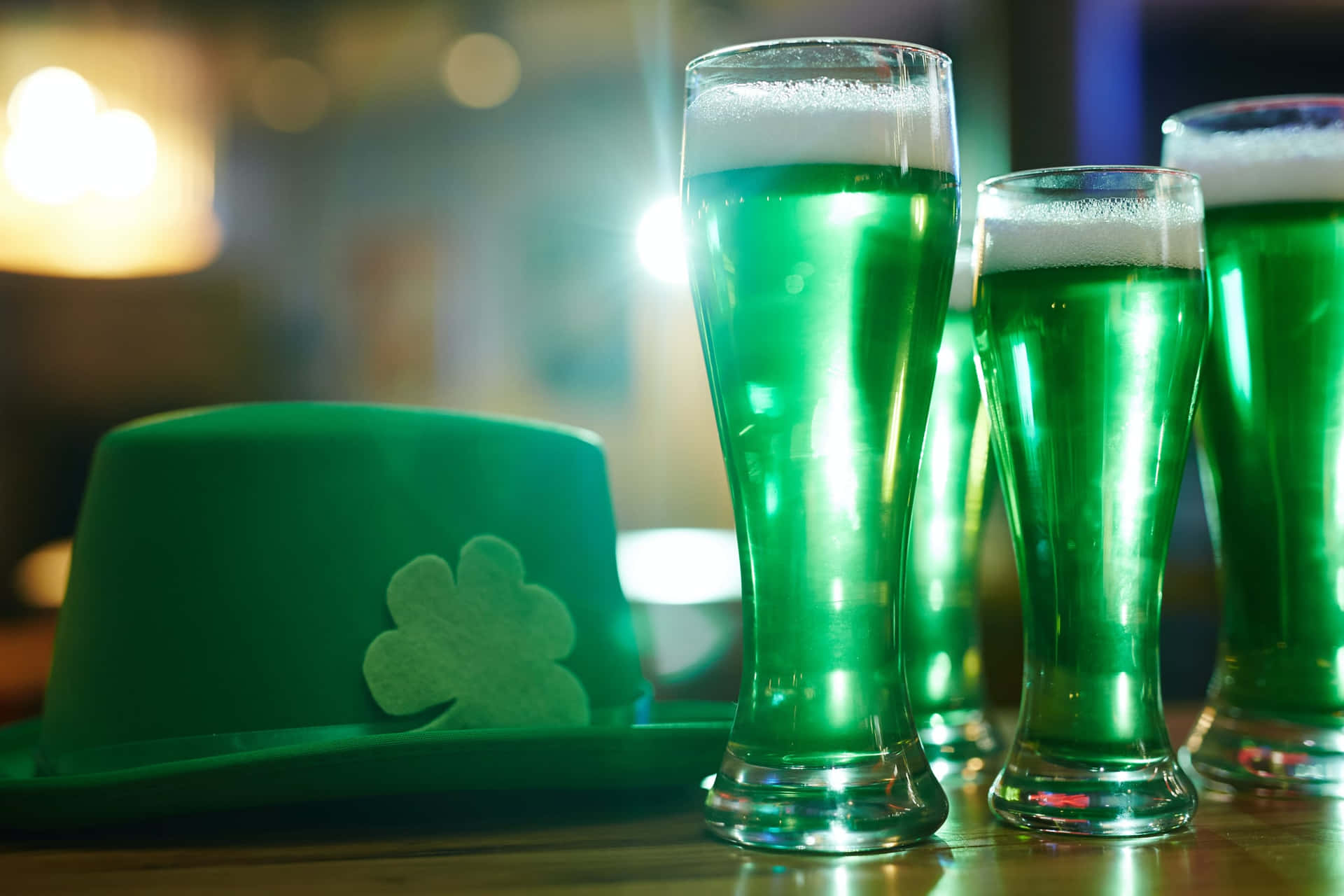 Three Glasses Of Green Beer With A Shamrock Hat