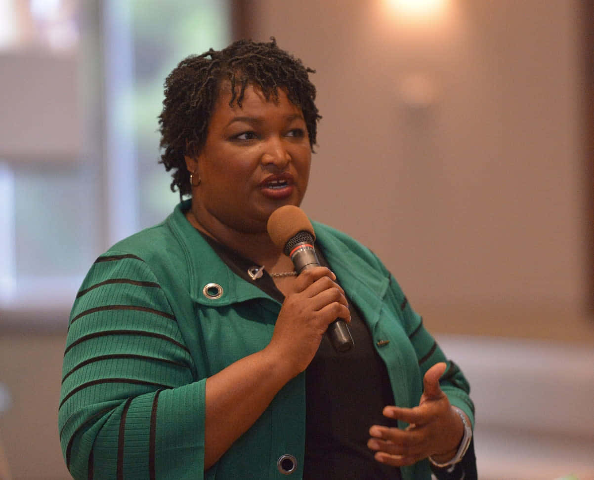 Stacey Abrams Speaking At A Rally Wallpaper