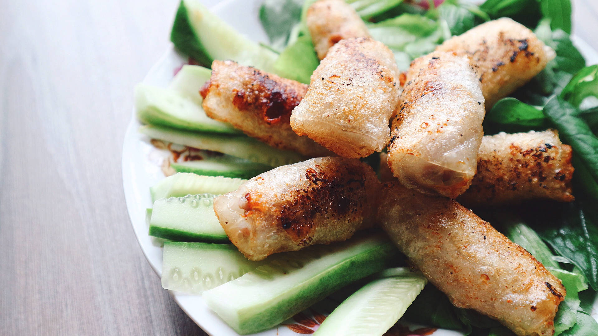 Stack Of Egg Rolls On Sliced Cucumbers