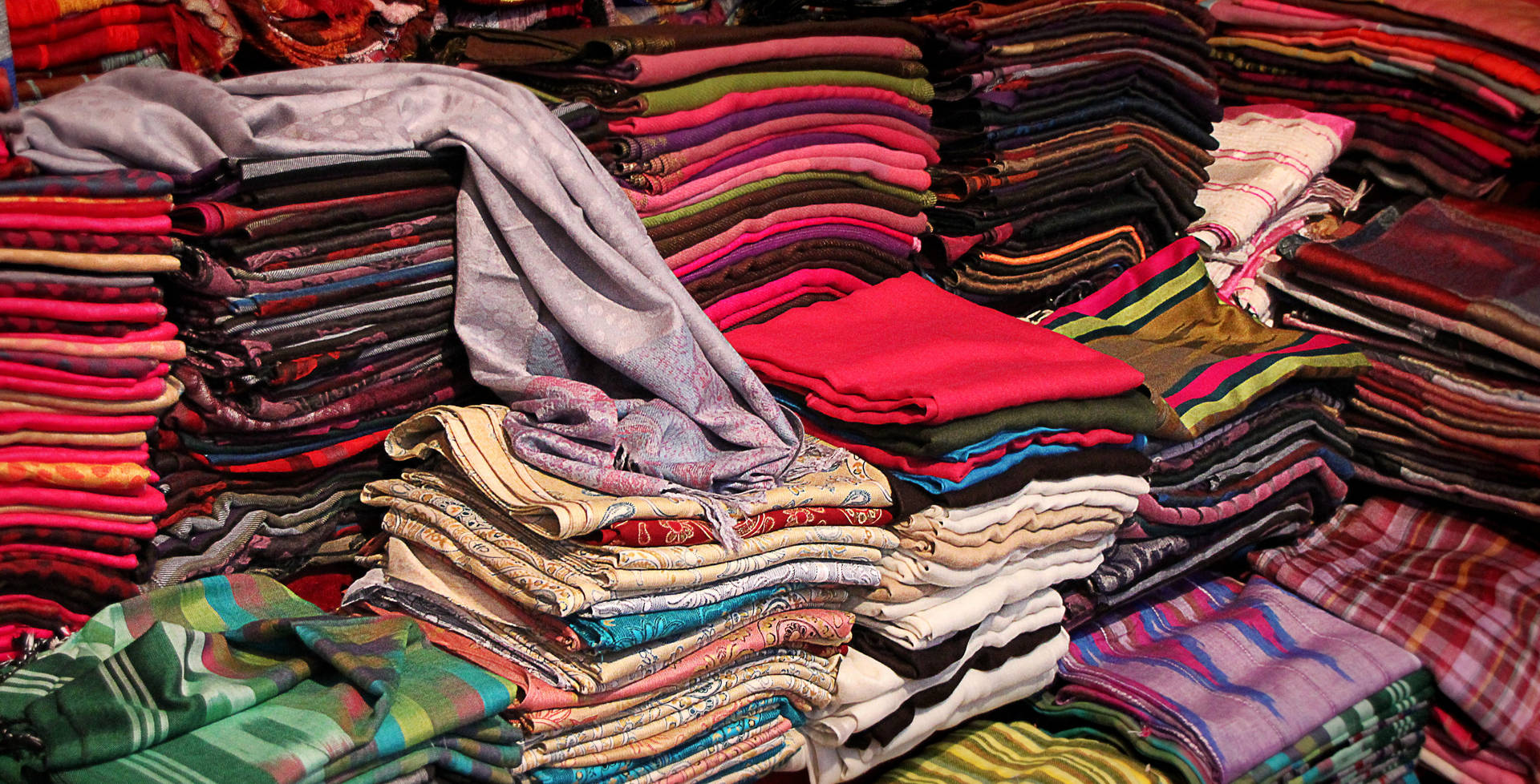 Stacks Of Clothes With Prints Background