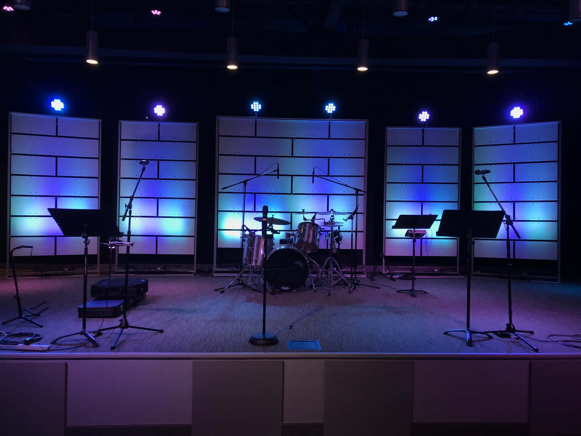 Church Stage With Microphones And Music Stands Background