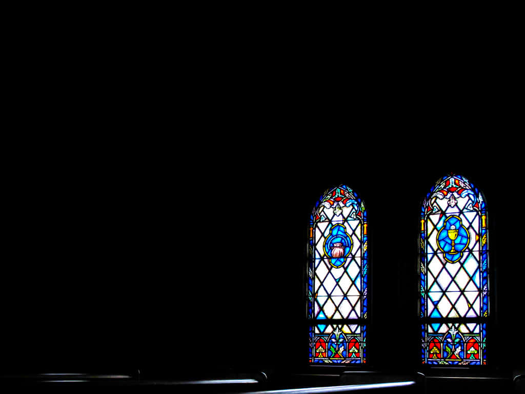 Two Stained Glass Windows In A Dark Church